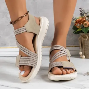 Beige wedge sandals for women with elastic cross straps and Velcro closure for casual wear.