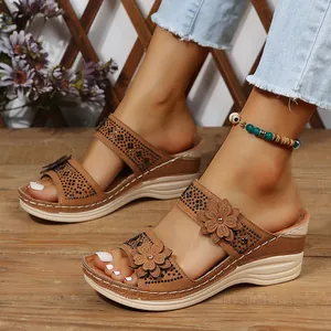 Detailed close-up of brown suede-like wedge sandals for women with floral and rhinestone accents