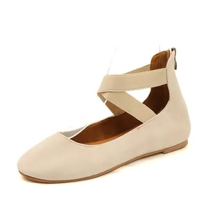 Elegant beige round toe ballet flats with elastic cross straps and back zipper detail.