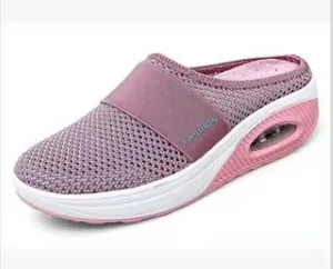 Side view of pink mesh wedge mules with air cushion sole and a 'FASHION' strap.