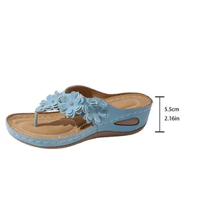 Women's blue wedge flip-flop sandals with floral decor and 5.5cm heel height measurement