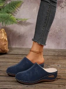 Blue suede wedge mules with white stitching detail and warm lining