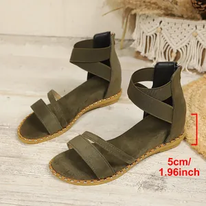 Close-up detail of olive green Roman sandals showing the 5cm heel height measurement.