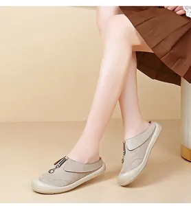 Detail side view of comfortable beige suede platform slip-on loafers worn by a model