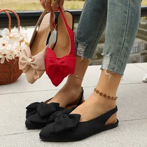 Elegant pointed-toe slingback flat sandals with large bow detail in multiple colors