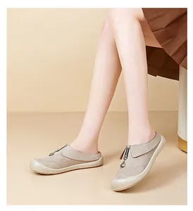 Detailed view of comfortable beige suede slip-on shoes for women with stylish zipper