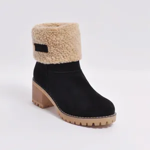 Close-up detail of black suede ankle boot with beige faux fur lining and chunky heel