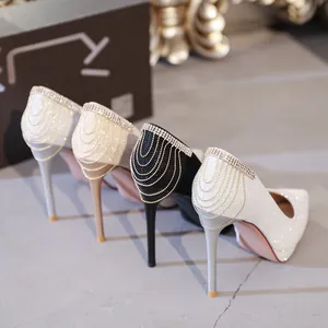 Elegante Pumps mit Pfennigabsatz und funkelnden Strassketten an der Ferse.