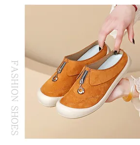 Detailed view of women's brown suede loafers with zipper ring accent and comfy thick sole