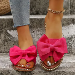 Elegant summer flat slippers for women featuring a large fuchsia bow and rhinestone trim