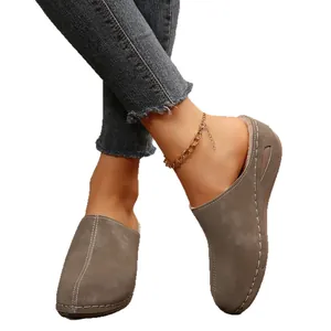 Elegant women's closed-toe wedge platform mules in taupe featuring white stitching