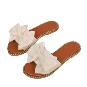 Elegant women's flat slides with a large bow and rhinestone-trimmed sole