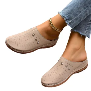 Women's beige closed-toe platform mules with decorative perforations and wedge sole