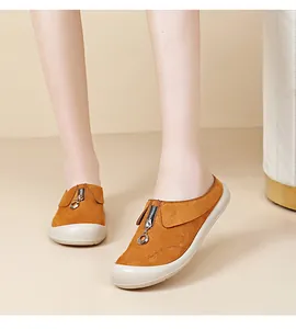 Close-up of orange suede slip-on shoes with front zipper and comfortable thick sole