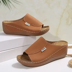 Fashionable brown women's wedge platform slide sandals with a thick comfortable sole