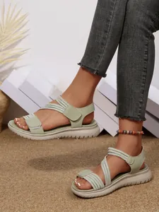 Casual mint green wedge sandals featuring comfortable adjustable velcro straps and sporty sole