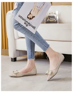 Champagne pointed-toe flat shoes with sparkling rhinestones and a delicate bow detail
