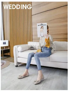 Model wearing elegant French-style pointed-toe flats with bow detail in a home