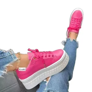 Vibrant pink women's platform sneakers with thick white soles and casual design