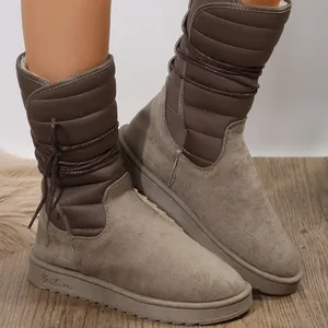 Detailweergave van warme sneeuwlaarzen voor dames met gewatteerd design en veterdetails