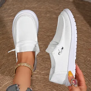 Detailed shot of white canvas loafers for women featuring textured non-slip rubber soles