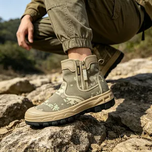 Close-up of men's camouflage tactical boots with side zipper on rocky terrain
