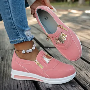 Nahaufnahme pinkfarbener Plateau-Sneaker mit goldenem Reißverschluss und M-Logo