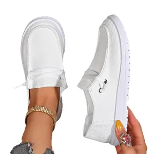 Casual white flat loafers for women featuring breathable canvas and comfortable slip-on design