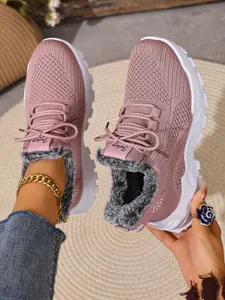 Detail van roze winter sneakers met een gebreid bovenwerk en een warme voering