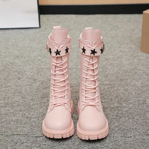 Detail view of pink girls' combat boots with black star studs and lace-up design