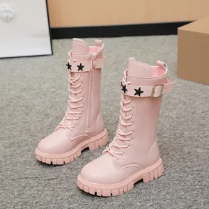 Close-up of pink girl's tall Martin boots with star buckle and lace-up details