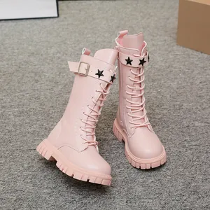 Close-up of pink girls' Martin boots with decorative star studs and lug soles