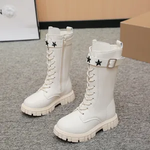 Close-up detail of cream girls' Martin boots featuring star rivets and functional side zipper