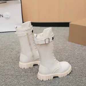 Detailed side view of girls off-white mid-calf combat boots featuring star buckle straps