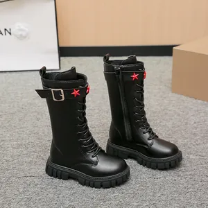 Close-up view of black children's tall Martin boots with red stars and side zipper