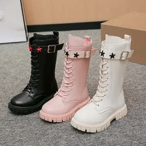Detail view of girls' mid-calf winter boots in black, pink, and off-white with star buckle.