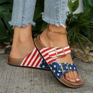 Close-up view of women's US flag pattern sandals featuring double metal buckles on foot.