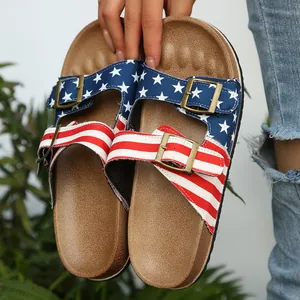 Close-up of American flag pattern on women's buckle sandals with stars and stripes.
