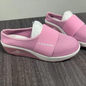 Detail view of pink mesh wedge mule slippers with air cushion sole and elastic strap.