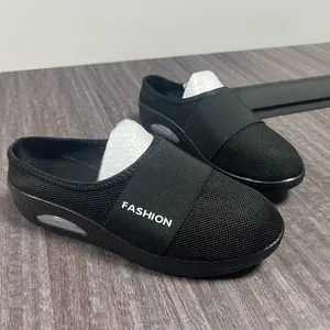 Detail view of breathable black mesh wedge mules with elastic fashion strap