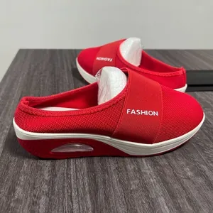 Detail view of red wedge mule sneaker showing mesh texture and air cushion sole.
