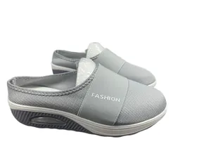 Grey breathable mesh wedge slip-on mules featuring elastic fashion strap detail.