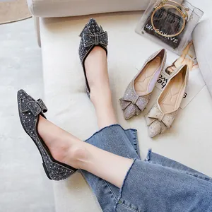 Elegant pointed-toe flat shoes with sparkling sequins and decorative bow details