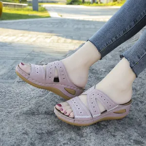 Gros plan de sandales à talons compensés roses avec broderie florale pour femmes dehors