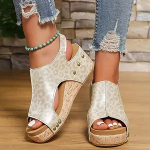 Close-up of leopard print wedge sandals with gold rivets and cork platform soles