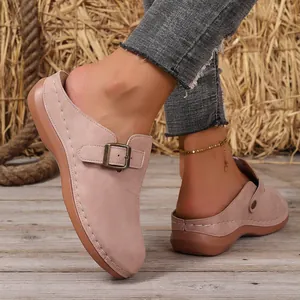 Close-up view of stylish dusty pink wedge mules featuring an adjustable buckle strap detail