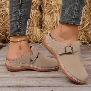 Close-up view of beige fashion platform closed-toe mules with buckle detail for women