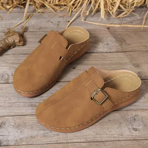 Rustic brown wedge mules for women featuring white stitching and decorative buckle