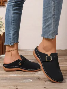 Casual black closed-toe wedge clogs for women featuring white stitching and buckle