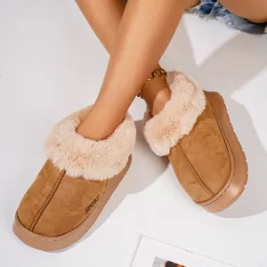 Close-up view of warm camel winter slippers with thick plush faux fur lining for women